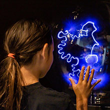 Young girl with glowing exhibit