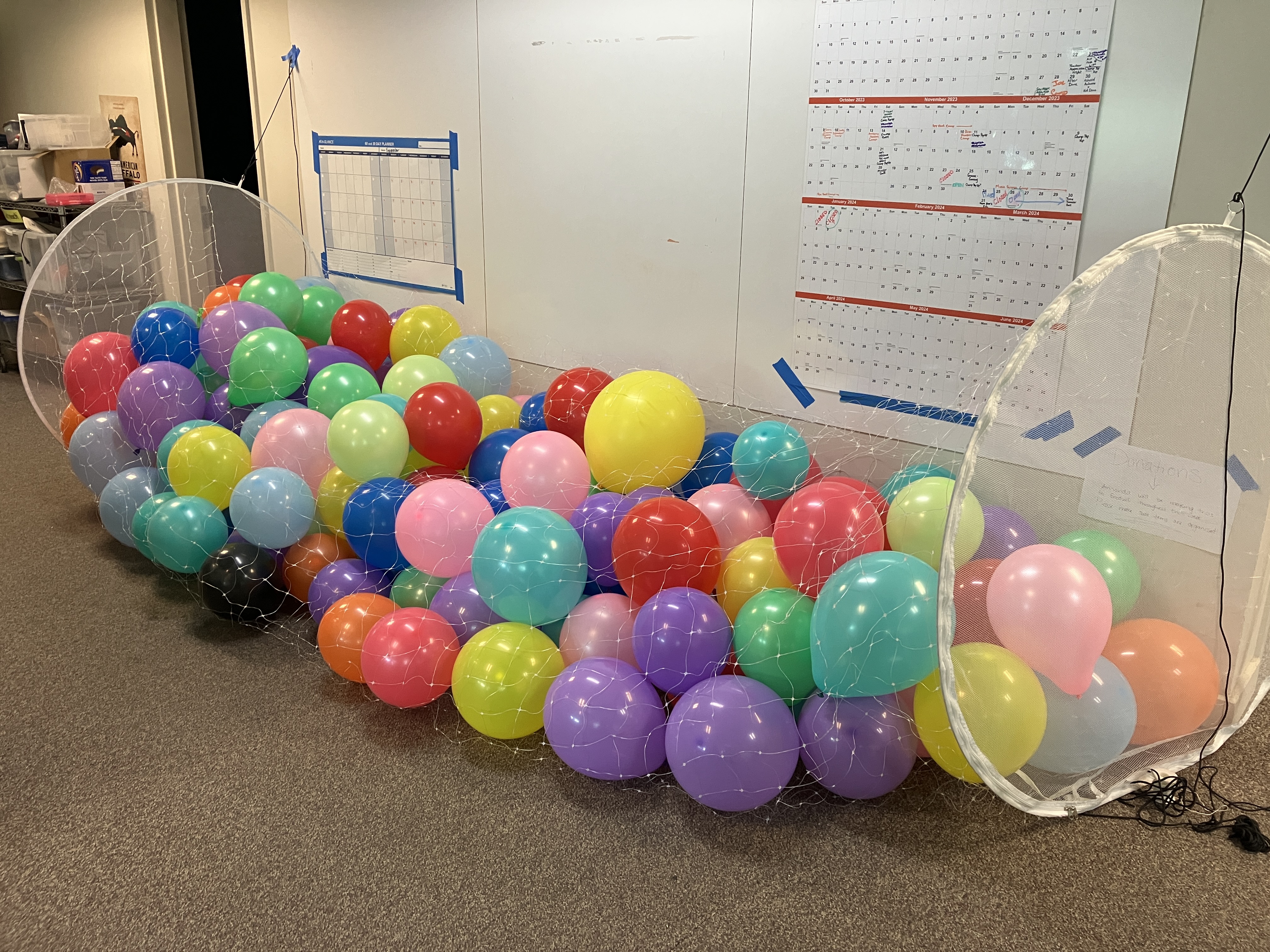 The balloon corral is filling up with balloons